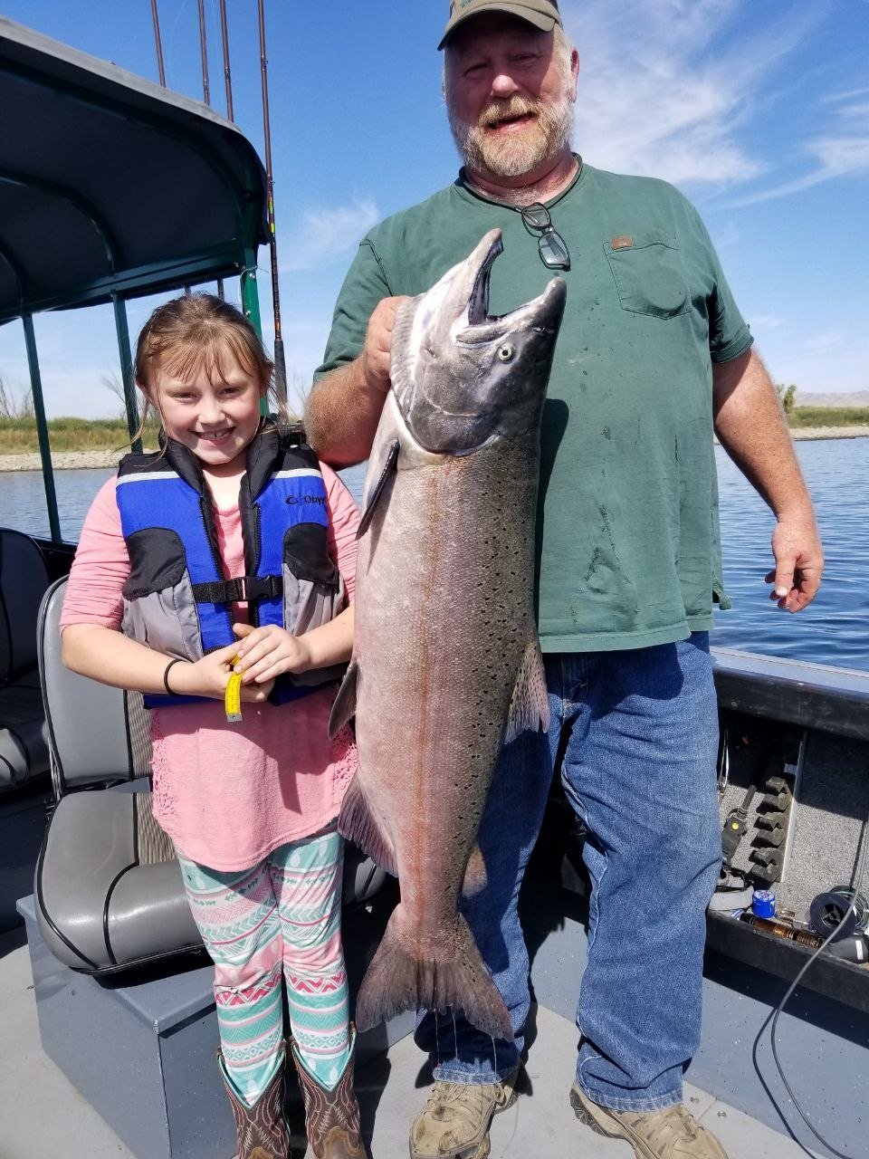 Family group with a large sturgeon